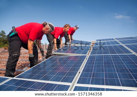 Photovoltaic installation on roof in Landshut, Bayern, Germany Royalty-Free Stock Photo #1571346358