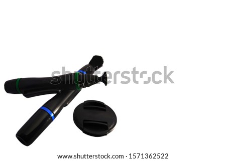 Lens cleaning pen and lens cap isolate white background.