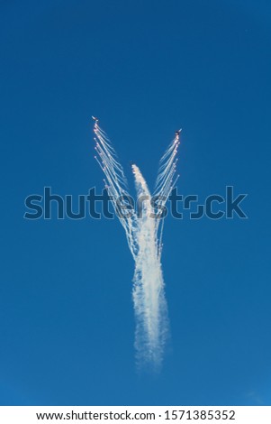 military aircraft in the sky at an air show