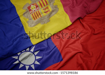 waving colorful flag of taiwan and national flag of andorra. macro