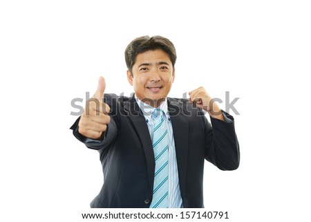 Happy business man showing thumbs up sign