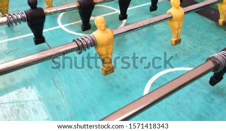 Table football game, Soccer table with yellow and black players.