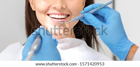 Teeth health concept. Cropped photo of smiling woman mouth under treatment at dental clinic, panorama Royalty-Free Stock Photo #1571420953