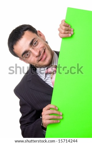 smiling businessman looks out from behind the green sheet