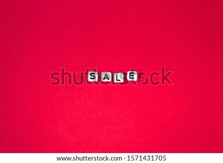 the word "sale" letters beads on a red background