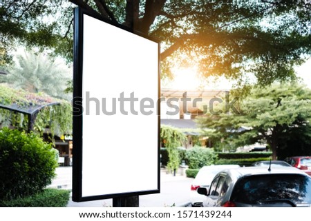 mock up of blank showcase billboard or advertising light box for your text message or media content with car in the parking lot in row, commercial, marketing and advertising concept. 