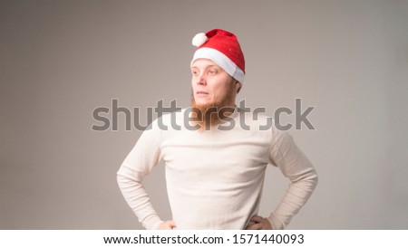 Portrait of a smiling young man in Santa Claus cap. Christmas celebration
