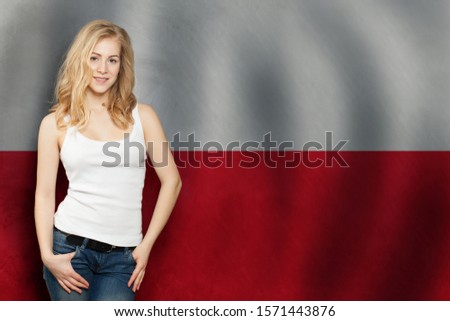 Cute Blonde young woman on the Poland flag background. Travel and learn polish language concept Royalty-Free Stock Photo #1571443876