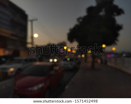 A picture of a car that is blurred at dusk.