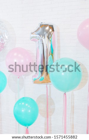 children's holiday silver balloon 1 year on the background of a white wall