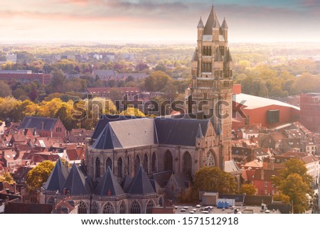 Panoramic aerial view of the old autumn city of Bruges from the viewing platform of the Belfort tower at sunset with a view of the Cathedral of St. Salvator, Belgium. Nice autumn colors