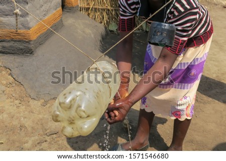 Hand washing station tippy tap in rural Malawi Royalty-Free Stock Photo #1571546680
