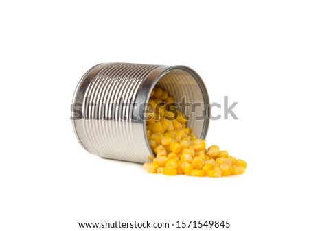 Canned corn on a white background. Corn closeup in an iron jar on a white background.