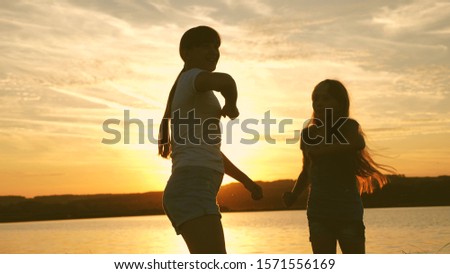 teens girlfriends holiday disco. party by lake, children dancing. happy girls dancing on the beach. beautiful girls having fun listening to music. sisters are dancing.