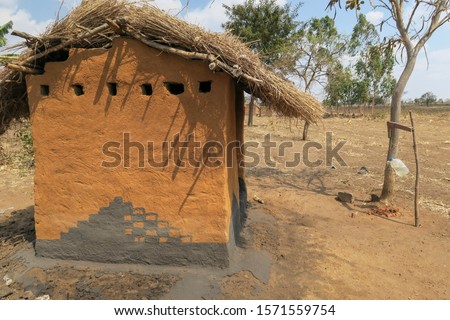 Toilet in rural Malawi with hand washing station Royalty-Free Stock Photo #1571559754