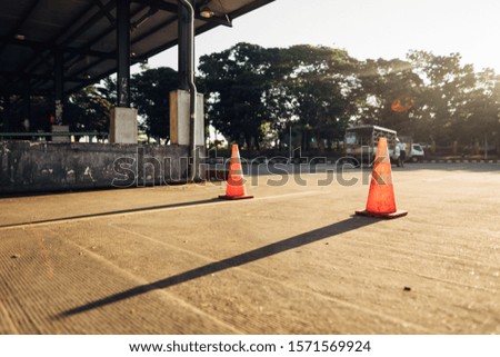 A beautiful shot of traffic cones with a blurred background on a sunny day