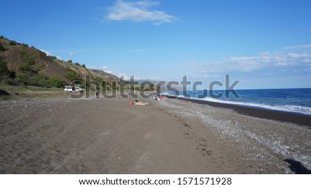 Black sand beach between Feodosia and Yalta, Republic of Crimea, Russia                                Royalty-Free Stock Photo #1571571928