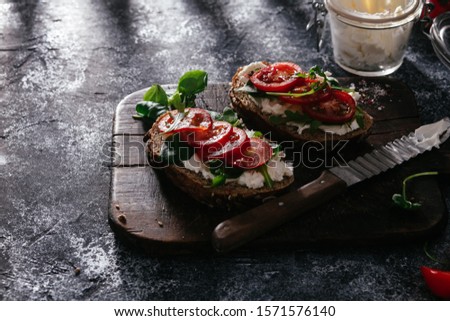 Whole grain bread bruschetta with cream cheese and cherry tomatoes