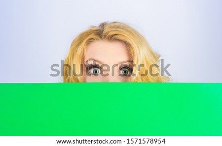 Woman hiding behind blank sign board. Advertising banner.  