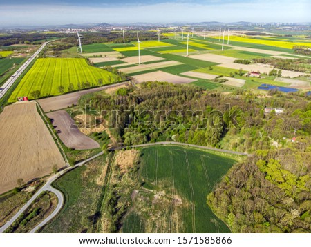 A drone photography of beautiful green fields of the countryside on a sunny day
