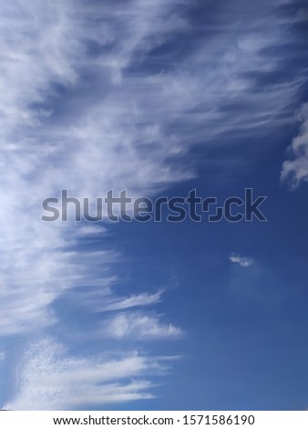 Colorful blue sky with cirrus clouds.