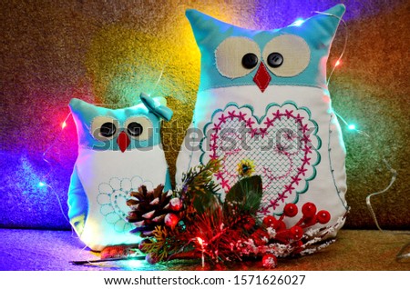 nice handmade owl on a brown background in christmas lights as decoration or desktop picture