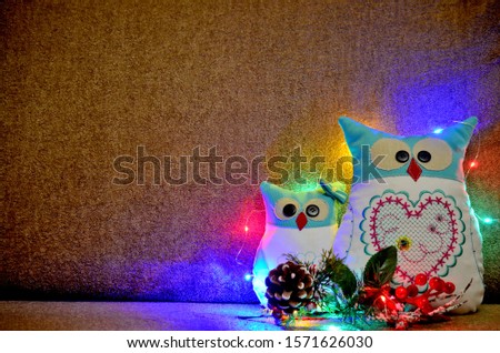 nice handmade owl on a brown background in christmas lights as decoration or desktop picture