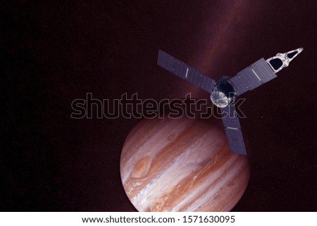 Satellite over Jupiter on a dark background. Elements of this image were furnished by NASA.