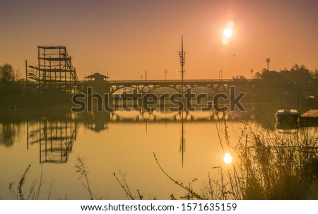 Sunrise at Tees Barrage. Bridge reflecting in the river Tees. Royalty-Free Stock Photo #1571635159