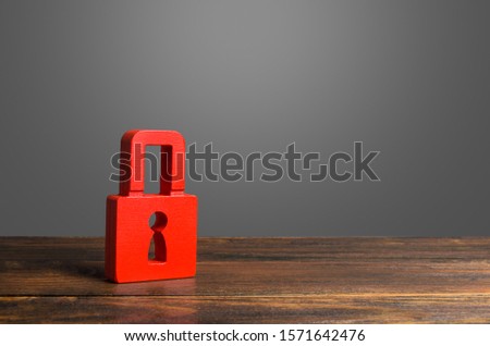 A red padlock. preservation of secrets, information and values. Protection and insurance. Hacking attack. Safety of personal data, privacy of users. Prevention of unauthorized access Royalty-Free Stock Photo #1571642476