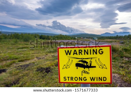 Strong wind road sign, helicopter warning flying sock crosswinds sidewind signage, hazard danger windsock icon red frame triangle roadsign pole post signpost.