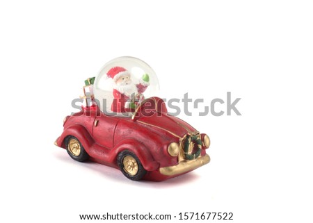 Christmas toy on a white background.  Santa Claus on a red retro car with gifts and a bear.  Happiness.  isolate. copy space 