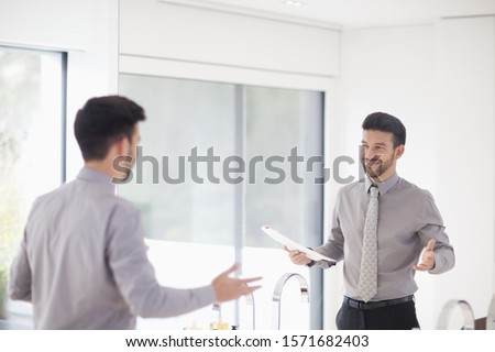 Mid adult businessman practicing presentation in mirror Royalty-Free Stock Photo #1571682403
