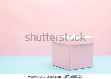 Empty, open white gift box on blue background with copy space