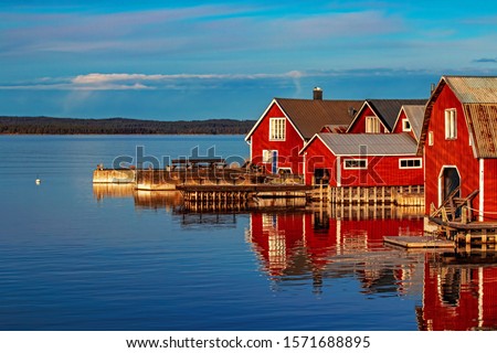 Red houses in village scenic landscape, Höga Kusten, Sweden Royalty-Free Stock Photo #1571688895
