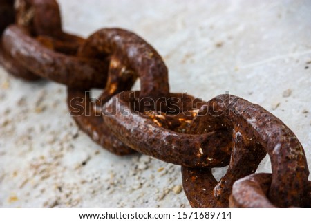 detail of a large rusty chain on a white background