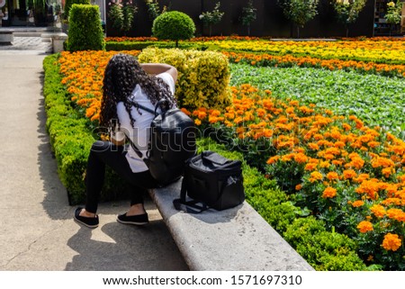 woman photographer taking picture of garden with camera.