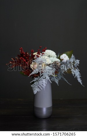 Christmas and New Year composition bouquet in a ceramic vase on a dark background, selective focus