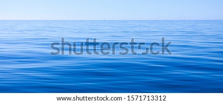 QUIET BLUE SEA LANDSCAPE ON THE COAST OF PORTUGAL Royalty-Free Stock Photo #1571713312
