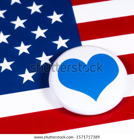 A blue heart symbol, pictured over the flag of the United States of America.