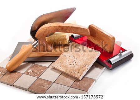 Spatula, trowel, a device for abrasive paper, ceramic tile on a white background