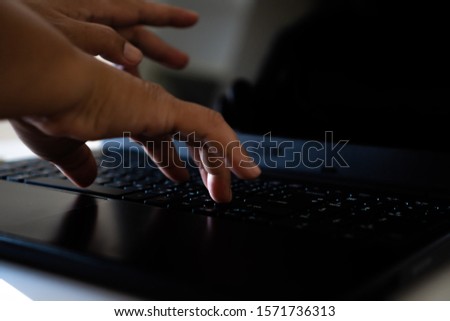 Hacker Crime Technology concept: hands of anonymous hacker typing code on keyboard laptop for remotely reach, receiving personal information online, Networking cyber Payment Security Concept