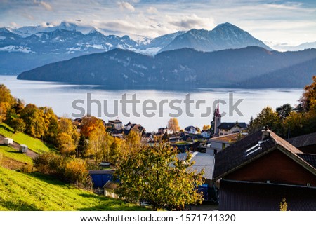 small mountain village and snowy peaks of Alps in the background