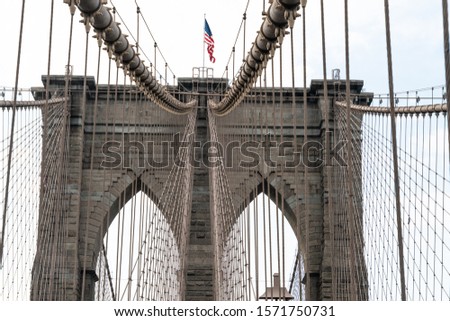 The Brooklyn Bridge And The Detail Inscribed In Its Unique Design With Cables And American Flag.