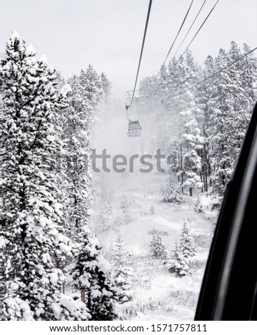 A winter gondola ride up a snowy mountain
