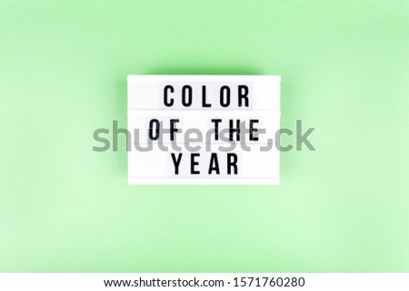 Retro lightbox with Color of the year wording on the trendy solid green backdrop, place for text