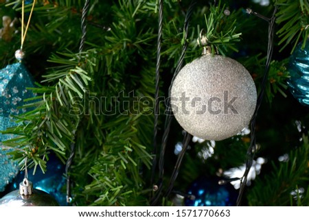 Closeup of Christmas Ball on Christmas Tree with bokeh beautiful background for design and decoration.