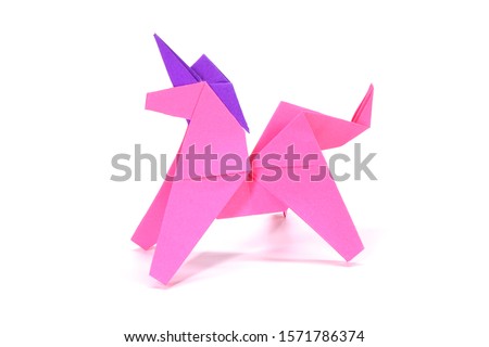 Unicorn. Pink unicorn origami paper art isolated on white background. Ideas for DIY hobby (Do It Yourself) for Children.                                