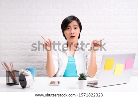 Portrait of a confused woman sitting at office