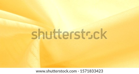 texture background, pattern. silk yellow fabric. From Telio, this organza has a thin, open weave that is thicker and sharper than silk gauze. Use this luxurious fabric for anything. The possibilities 
